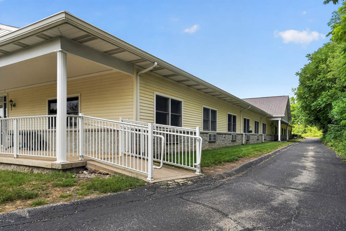 Accessible entry with covered porch and ramp at Golden Heights