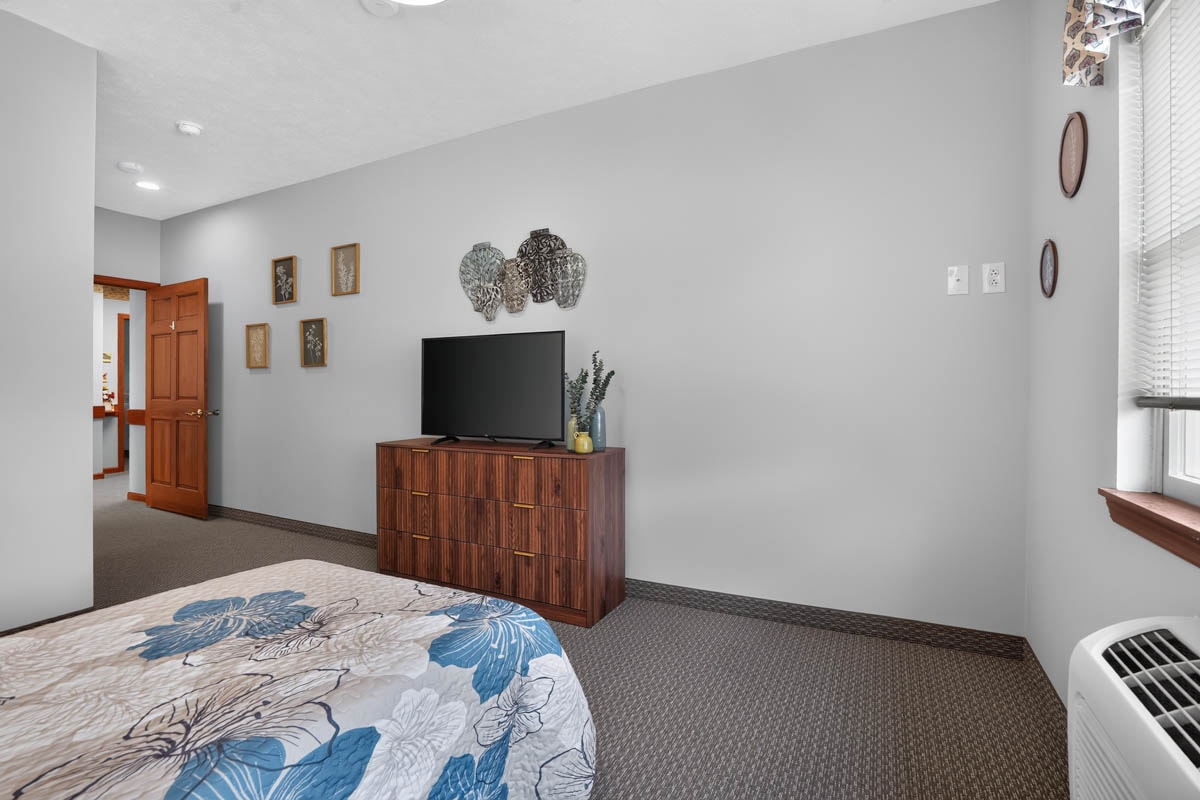 Resident bedroom with dresser at Golden Heights