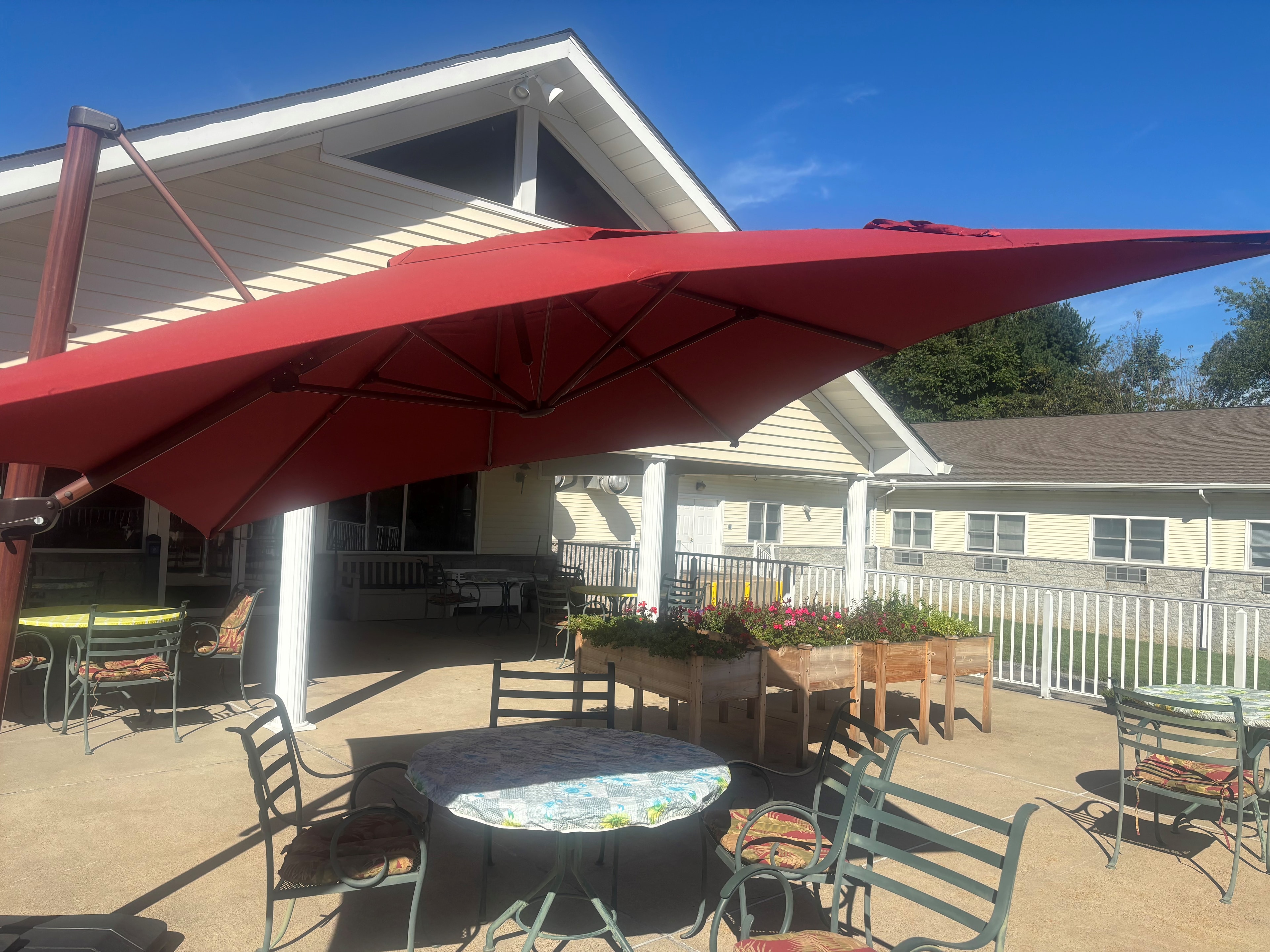 Rear terrace with umbrella and patio seating at Golden Heights